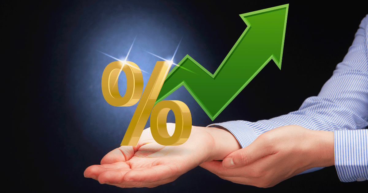 A person in a blue-striped shirt holds a golden percent symbol and a large green upward arrow, illustrating increasing growth and Profit First percentages, on a dark background.