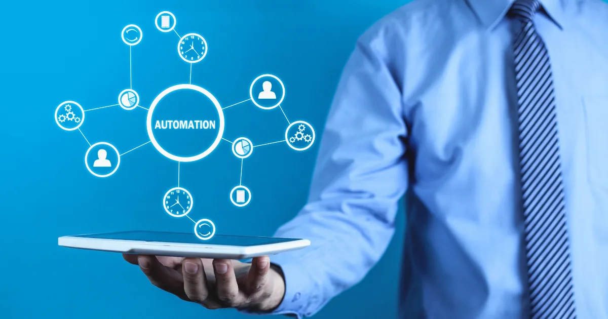 A person in a business shirt holds a tablet with a digital graphic above it showing connected automation icons, including fulfillment automation, representing workflow, people, gears, and time management on a blue background.