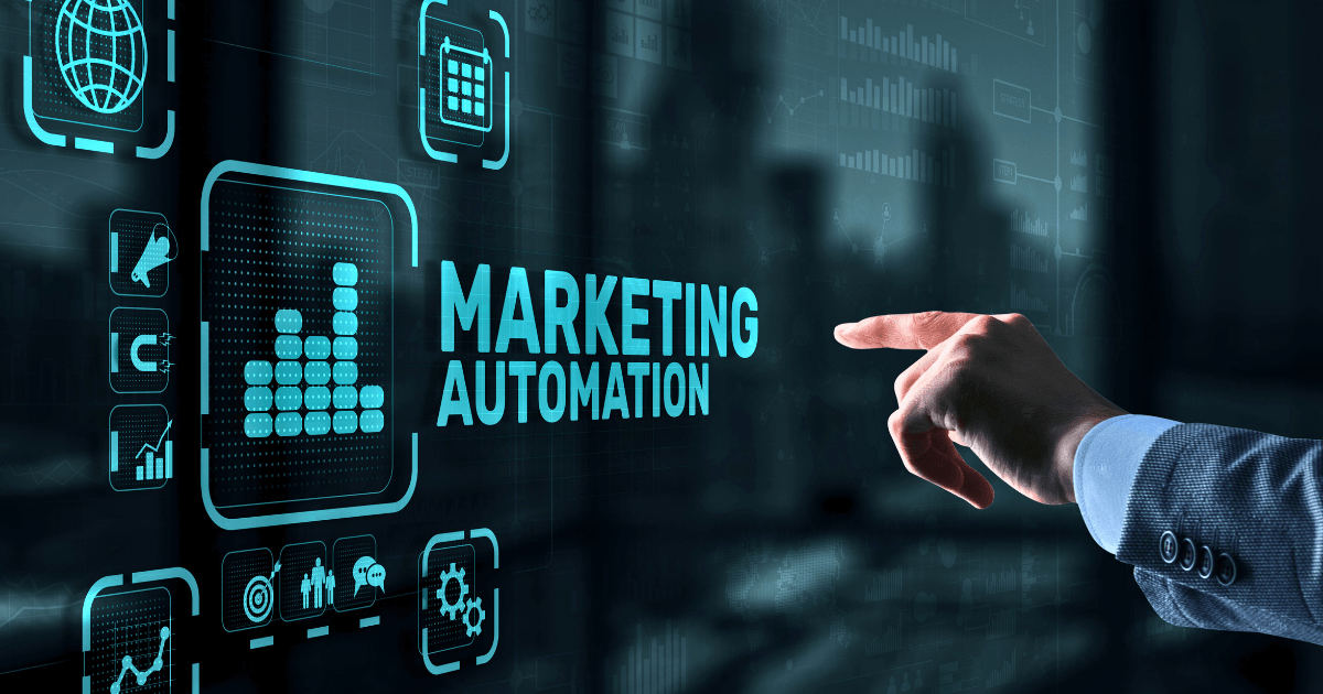 A person’s hand points at a digital screen displaying “Marketing Automation,” surrounded by icons and futuristic graphics, visually illustrating the power of marketing automation technology and streamlined marketing processes.