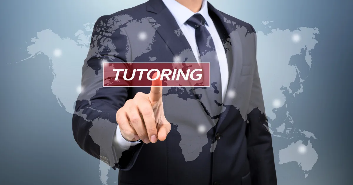 A man in a suit points at the word ONLINE TUTORING on a transparent screen, with a blurred world map in the background.