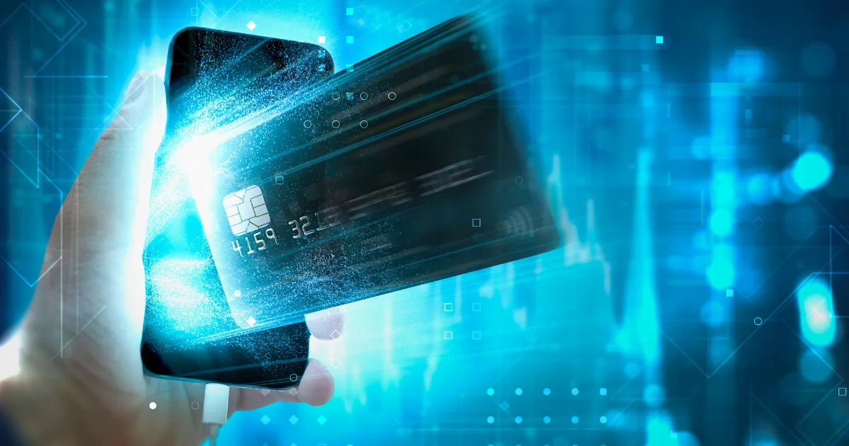 A hand holds a smartphone as a glowing credit card floats above it, symbolizing digital payments, payment processor comparison, and modern financial technology on a blue, futuristic background.