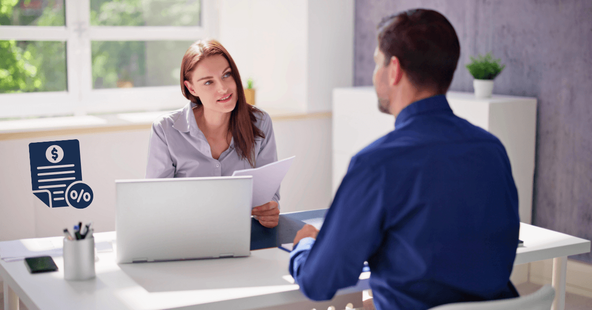 A woman and a man sit across from each other at an office desk, engaged in discussion. The woman holds papers on tax strategy for entrepreneurs, and a laptop is in front of her. An illustrated financial document icon appears on the left side.