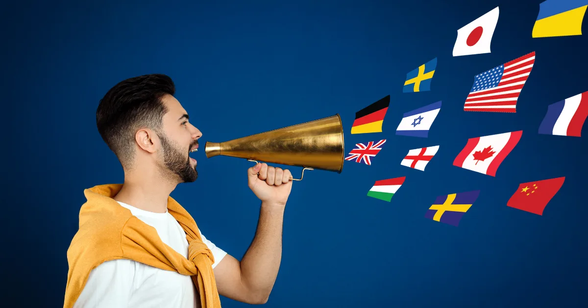 A man holding a gold megaphone speaks, with various international flags emerging from the megaphone against a blue background, symbolizing multilingual communication and the global reach of online translator jobs.